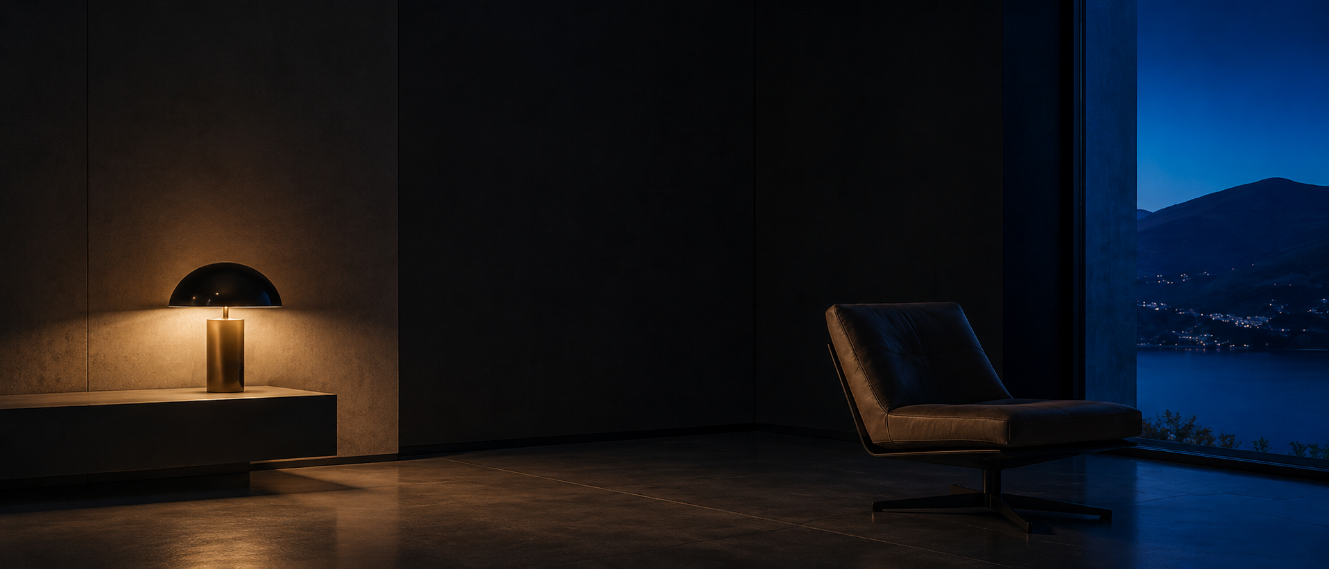 A calm interior at dusk with a single low lamp