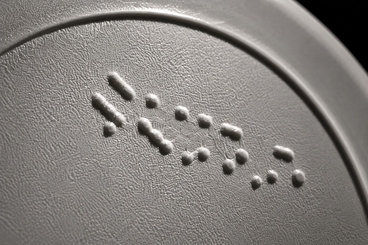Macro of an embossed batch code on the base of a bottle