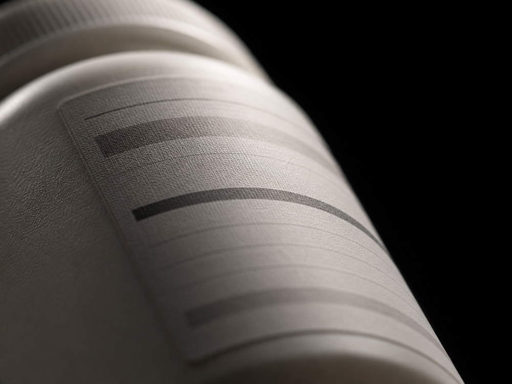 Macro of the back panel of a supplement bottle, type blurred